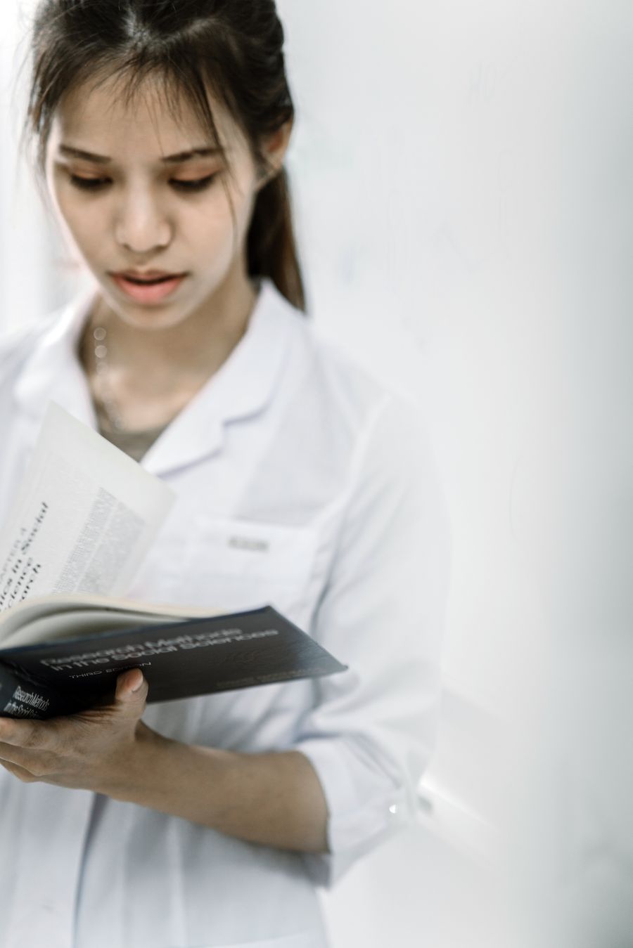 A healthcare graduate studying clinical notes at a desk.